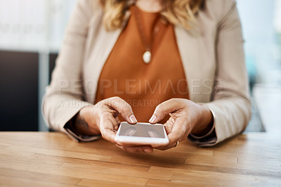 Buy stock photo Shot of an unrecognizable businesswoman using a cellphone while working in her office