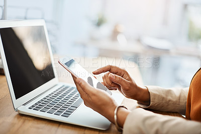 Buy stock photo Shot of an unrecognizable businesswoman using a cellphone and laptop in her office