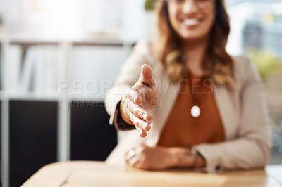 Buy stock photo Shot an unrecognizable businesswoman reaching out for a handshake in her office