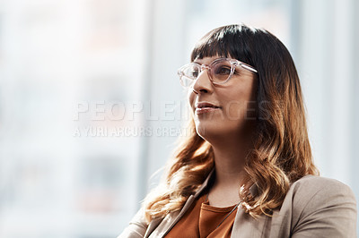 Buy stock photo Shot of an attractive young businesswoman looking thoughtful in her office