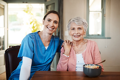 Buy stock photo Shot of a young nurse sitting with a senior woman at breakfast time in a nursing home