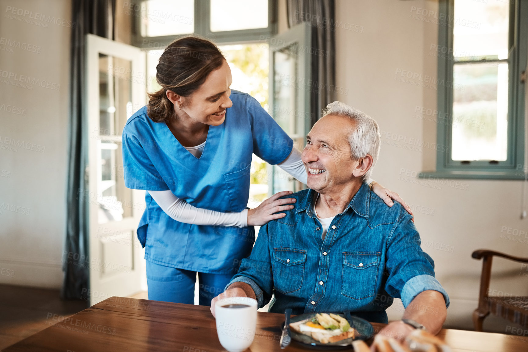 Buy stock photo Shot of a young nurse checking up on a senior man during breakfast at a nursing home