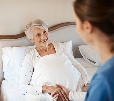 Buy stock photo Nurse, elderly woman and holding hands in bed, support and kind with news of recovery in home. Caregiver, homecare and listen to medical consulting, senior person and patient for results on illness