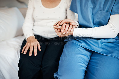 Buy stock photo Cropped shot of a nurse holding hands with a senior woman