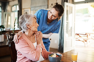Buy stock photo Healthcare, elderly woman with nurse with breakfast at her home and at the table in living room. Support or communication, caregiver and conversation with medical person with senior or old female.