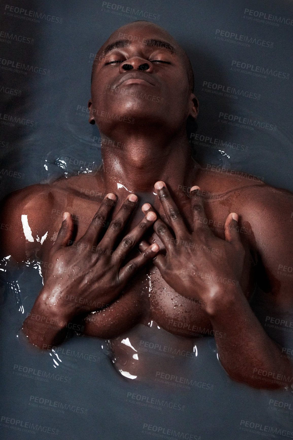 Buy stock photo Black man, bathing and charcoal water with eyes closed for skincare, detox and anti aging or ph level. Male person, muscular and dark liquid in bath for art deco, beauty and abstract creativity