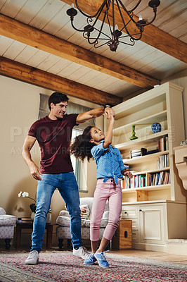 Buy stock photo Full length shot of a happy young father and daughter dancing together at home