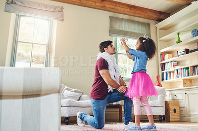 Buy stock photo Full length shot of a happy young father playing dress up with his daughter at home