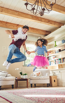 Buy stock photo Full length shot of a happy young father playing dress up with his daughter at home