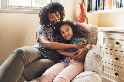 Buy stock photo Portrait of a happy young mother and daughter relaxing together on a couch at home