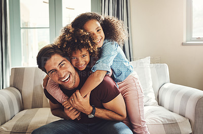 Buy stock photo Portrait of a happy young father playing with his two children at home