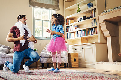 Buy stock photo Full length shot of a happy young father playing dress up with his daughter at home