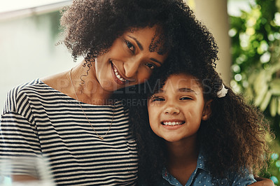 Buy stock photo Portrait of a beautiful mother and daughter posing together during a family gathering at home