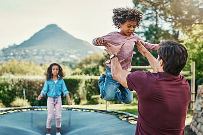 Buy stock photo Shot a father playing with his young children at a park outdoors