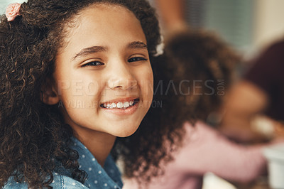 Buy stock photo Portrait of an adorable little girl enjoying herself during a family gathering