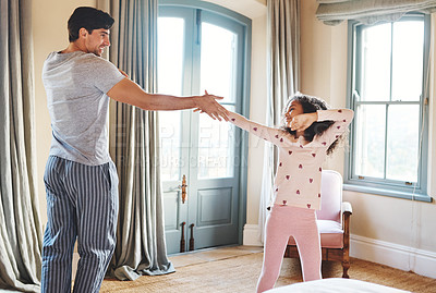 Buy stock photo Shot of a father and his little daughter dancing together at home