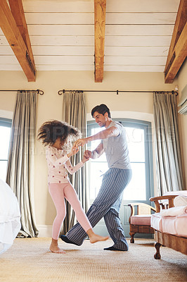Buy stock photo Shot of a father and his little daughter dancing together at home