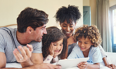 Buy stock photo Shot of a family using a digital tablet together at home