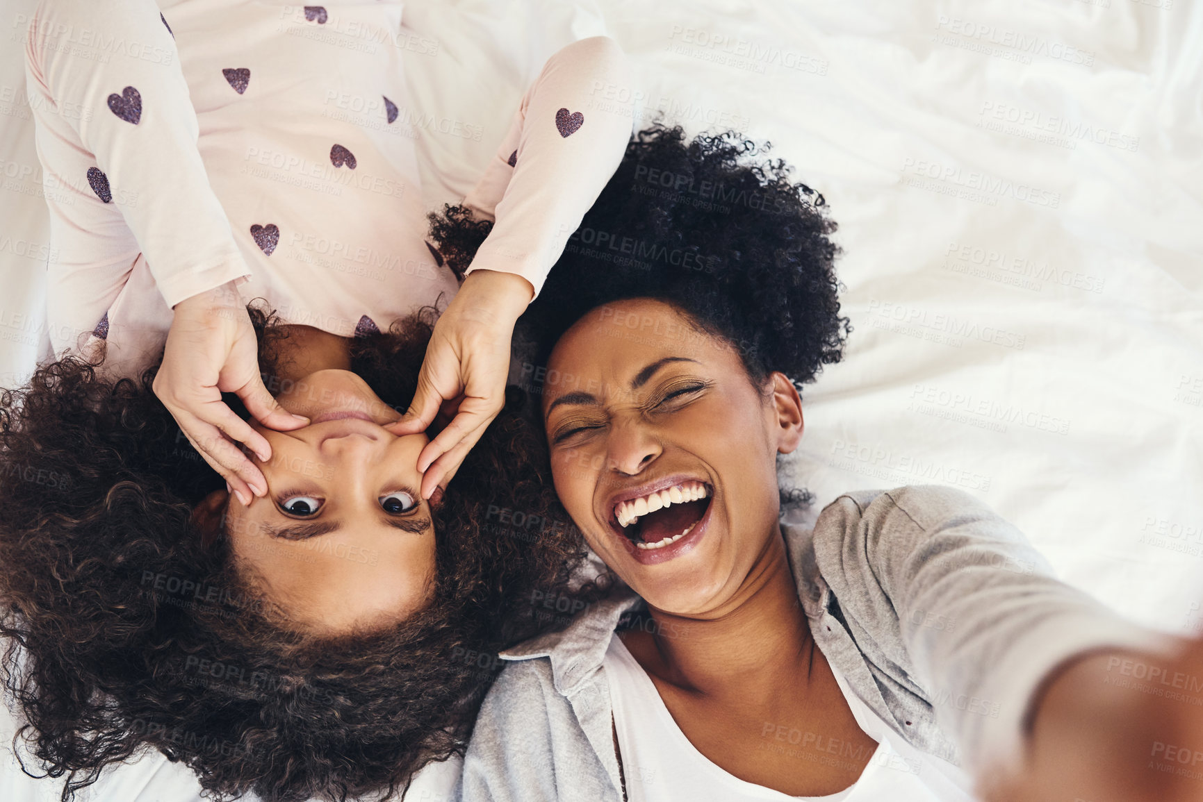 Buy stock photo Selfie, funny face and mom with child on bed for memory, social media post or photography in bedroom. Top view, laugh and African woman with girl for profile picture, happiness or relax POV in home