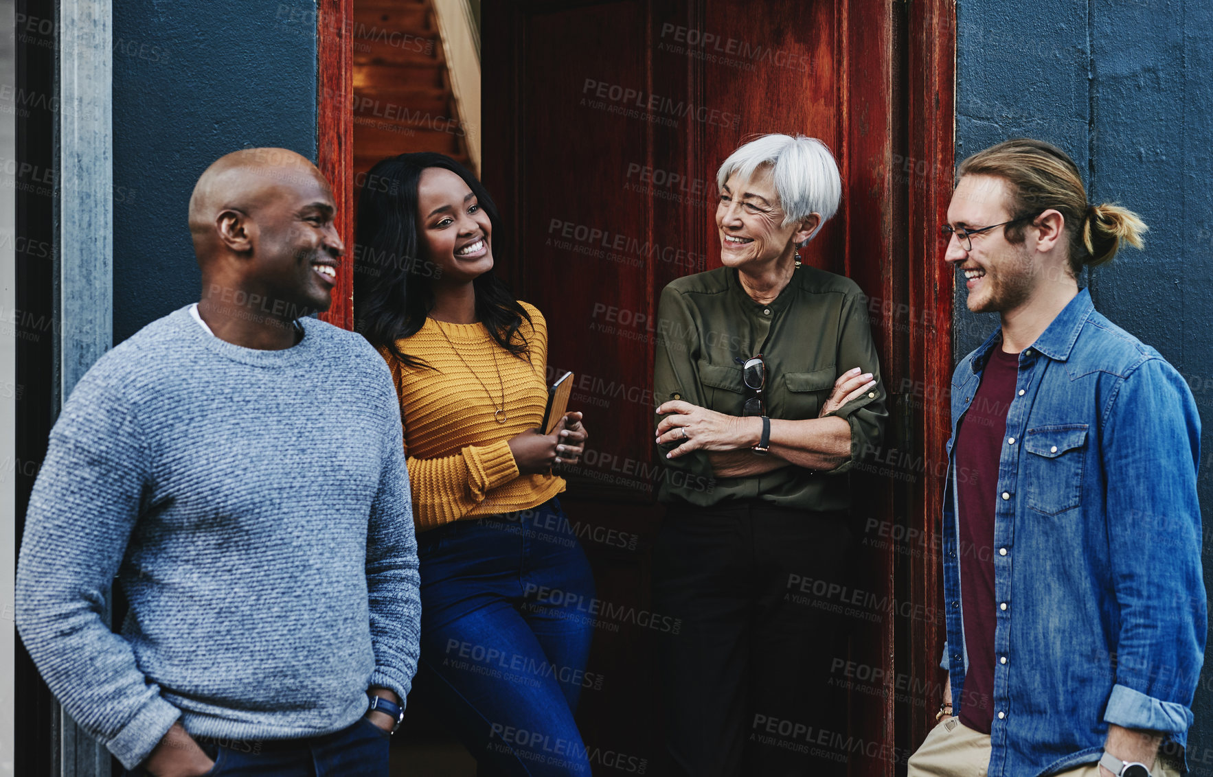 Buy stock photo Shot of a group of businesspeople having a discussion together while standing outside their office building
