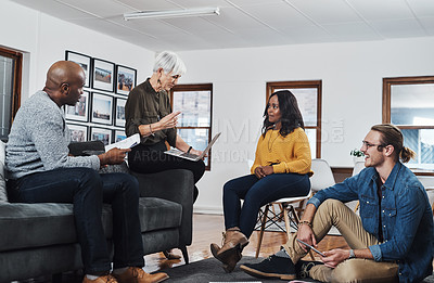 Buy stock photo Shot of a group of businesspeople having a meeting and discussing ideas in their office at work