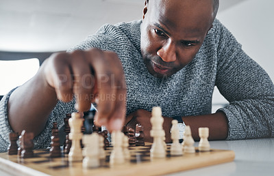 Buy stock photo Shot of a mature businessman playing chess in his office