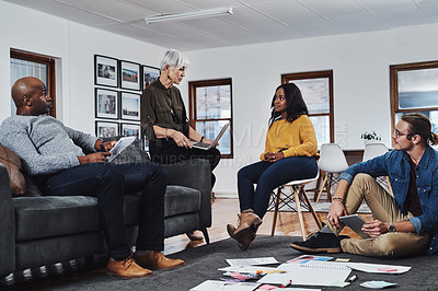 Buy stock photo Shot of a group of businesspeople having a meeting and discussing ideas in their office at work
