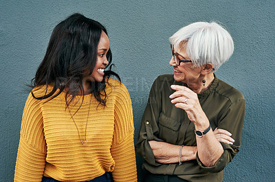 Buy stock photo Senior businesswoman, break and conversation with employee, friend or colleague in discussion outside work on blue background. Women, talking and happy together or black woman, mature person smile