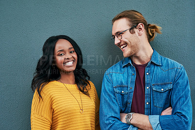 Buy stock photo Love, portrait and happy couple laughing against a wall background, bonding and having fun. Interracial relationship, smile and african woman with man outdoors relax and enjoying date or conversation
