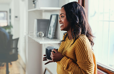 Buy stock photo Cropped shot of an attractive young businesswoman enjoying a coffee while standing in her office