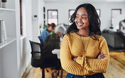 Buy stock photo Cropped shot of an attractive young businesswoman looking thoughtful while standing with her arms folded in the office
