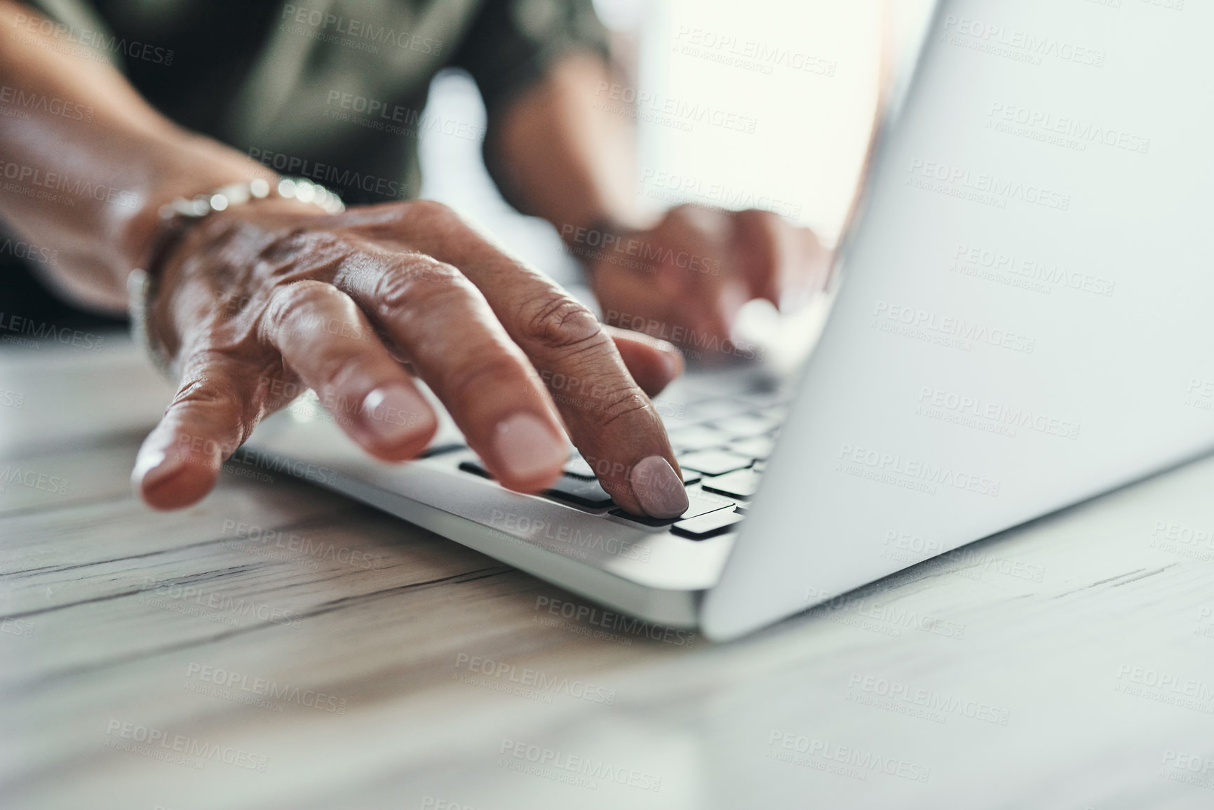 Buy stock photo High angle shot of an unrecognizable businesswoman working on her laptop in the office