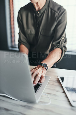 Buy stock photo High angle shot of an unrecognizable businesswoman working on her laptop in the office