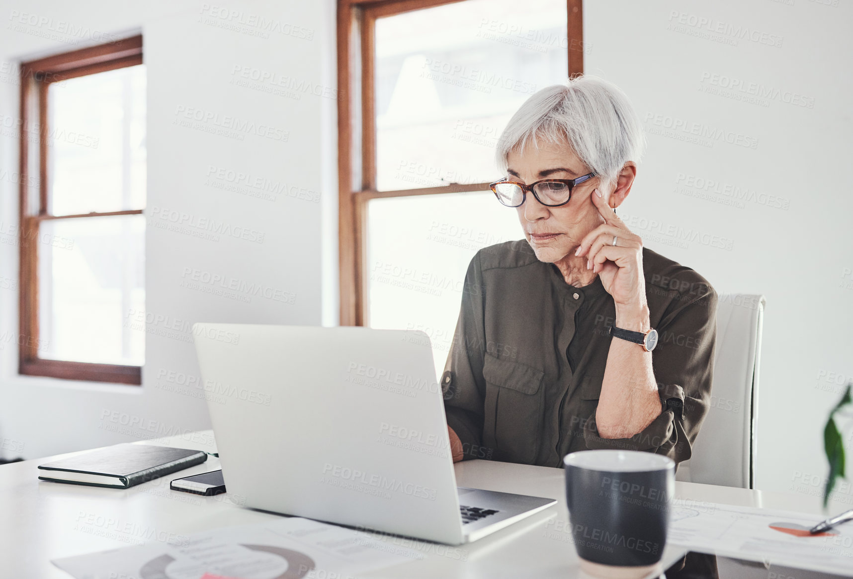 Buy stock photo Laptop, planning and mature woman in office checking email, online report or market research on website. Reading, thinking and creative businesswoman at desk working on agenda for business growth