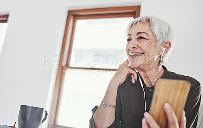 Buy stock photo Cropped shot of an attractive mature businesswoman listening to messages on her cellphone while sitting in the office