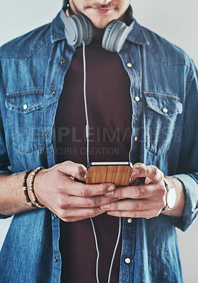 Buy stock photo Cropped shot of an unrecognizable businessman listening to messages on his cellphone
