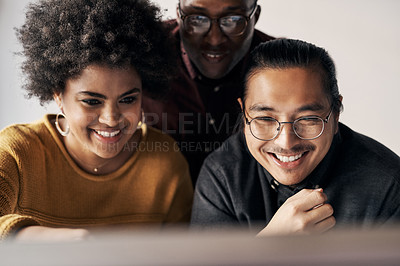 Buy stock photo Cropped shot of a group of young businesspeople sitting and working together in the office during the day