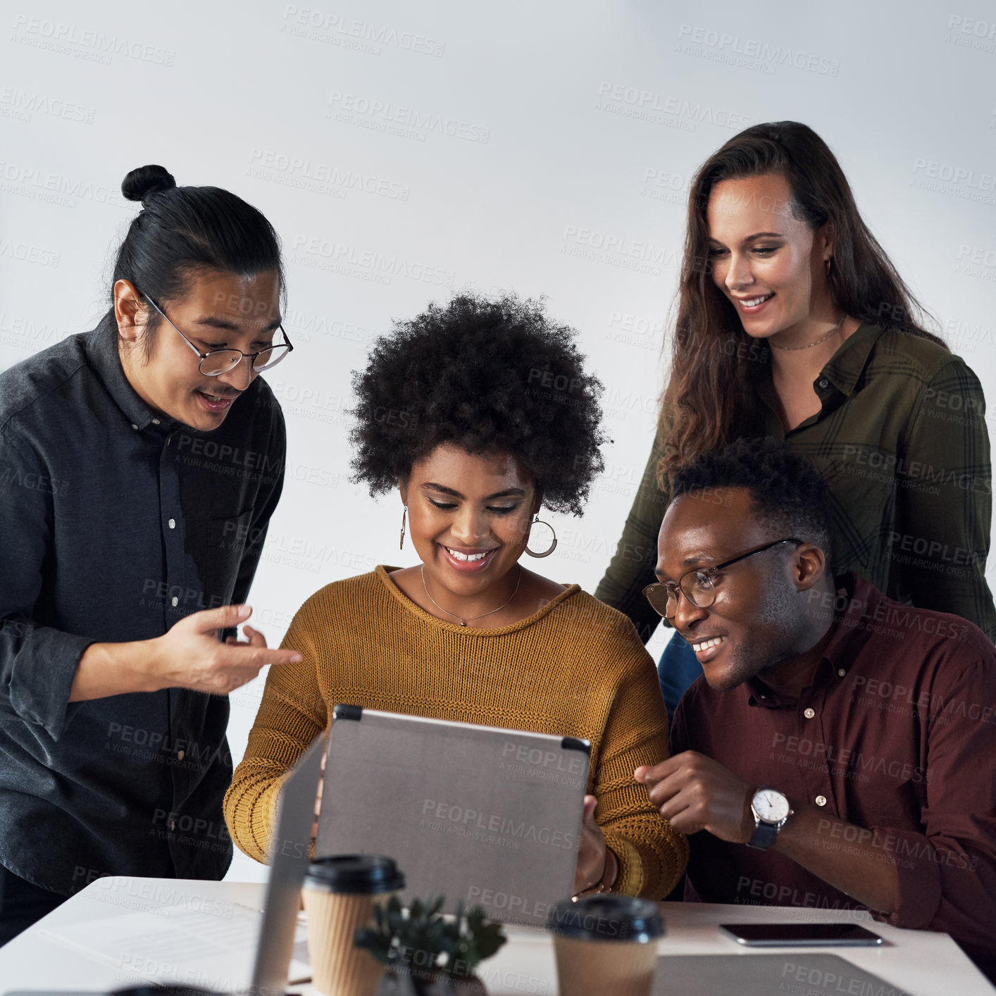 Buy stock photo Cropped shot of a diverse group of businesspeople working on a tablet together in the office