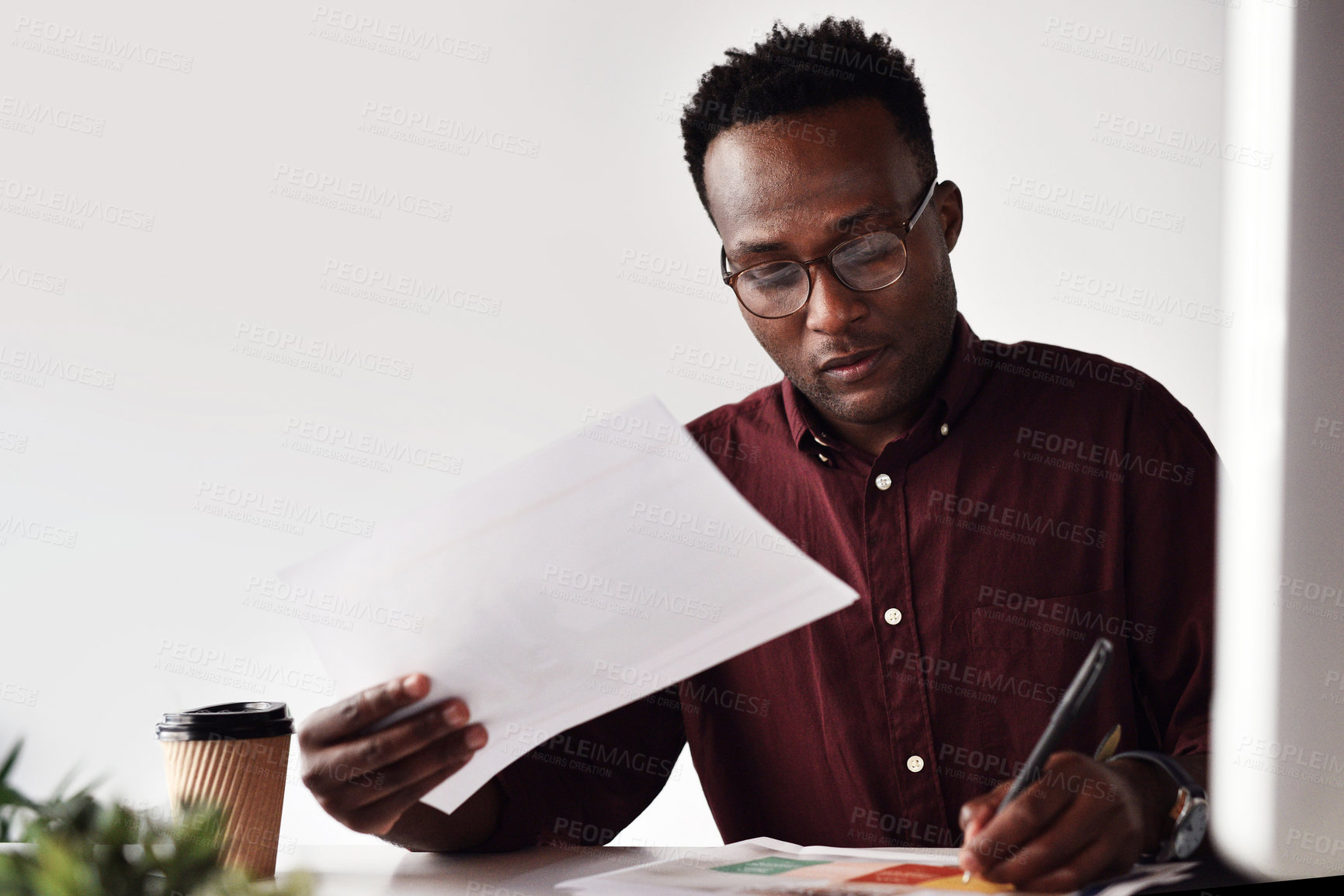 Buy stock photo Glasses, black man and documents in office for planning, notes and contract information for reading. Creative agency, professional career and male designer with paper for review, schedule plan or pen