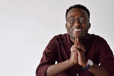 Buy stock photo Cropped portrait of a handsome young businessman sitting alone and smiling in the office