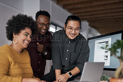 Buy stock photo Cropped shot of a group of young businesspeople working on a laptop together in the office