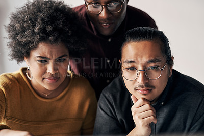 Buy stock photo Cropped shot of a group of young businesspeople sitting and working together in the office during the day