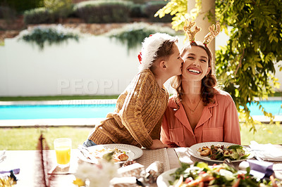 Buy stock photo Mom, girl and kiss for Christmas, bonding and lunch outdoor with food, sunshine and home in backyard. Mother, daughter and happy for holiday, celebration and brunch with support, family and embrace