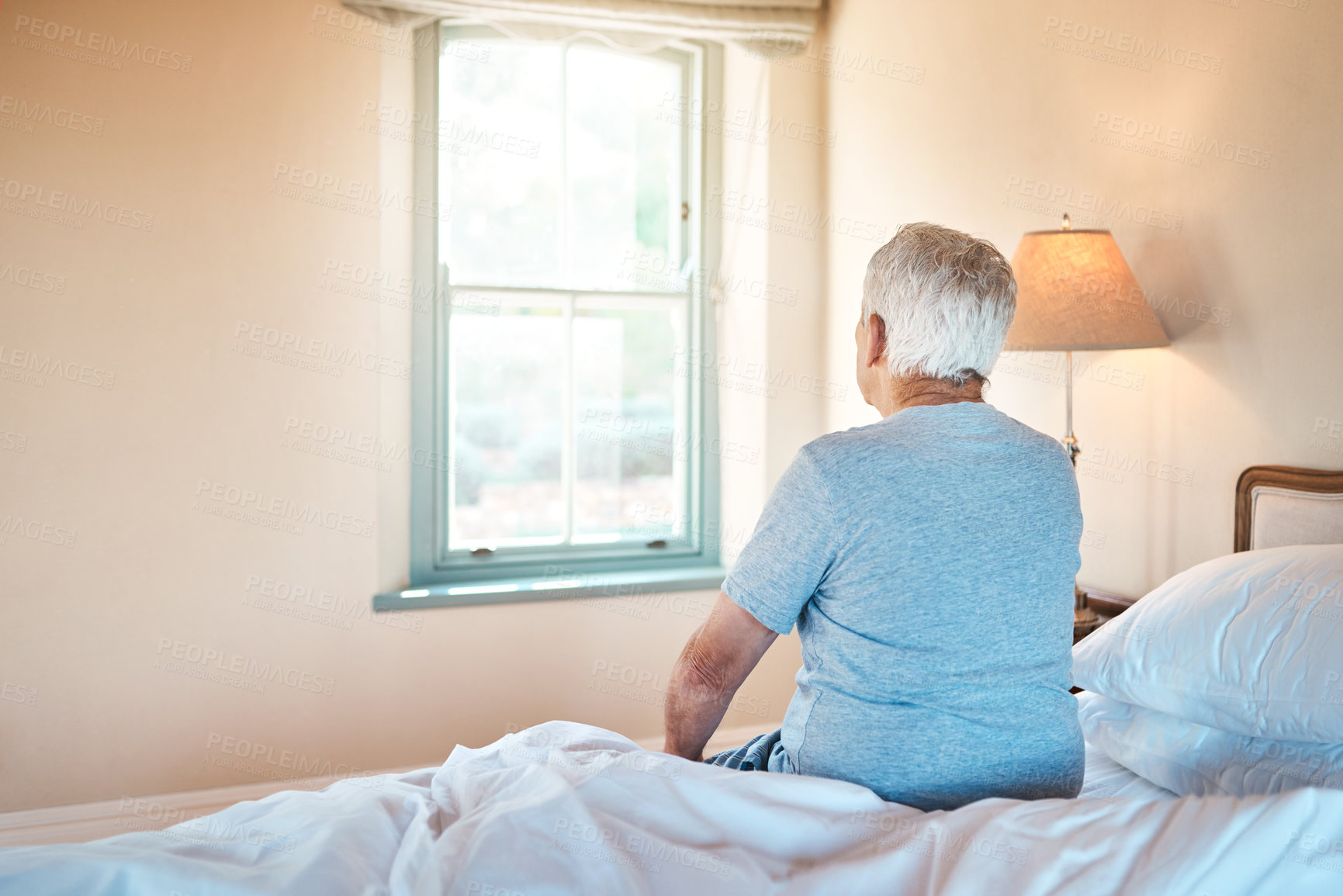 Buy stock photo Back, thinking and old man sitting on bed, retirement and relax with memory, nostalgia and calm. Window, pensioner and senior person in bedroom, view and lonely with emotion, house and start day