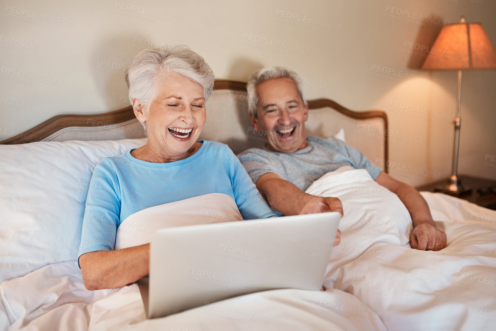 Buy stock photo Senior, couple and laughing with laptop in bedroom for social media, browsing internet and watch funny videos. Elderly people, happy and home with technology for comedy movie and entertainment.