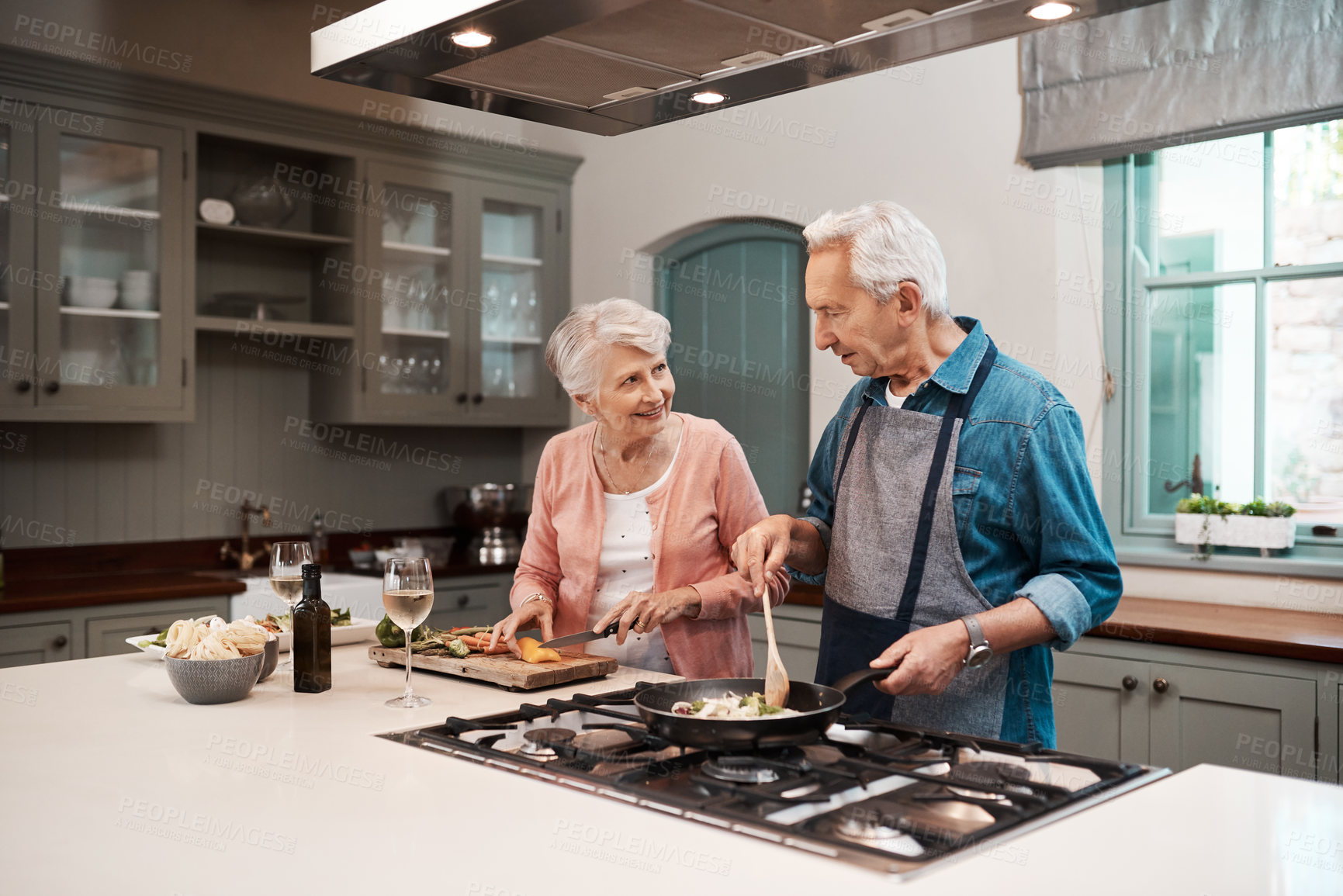 Buy stock photo Help, senior couple and cooking in kitchen, love and nutrition with healthy meal, talking and food. House, pensioner and old man with elderly woman, recipe and romance with hobby and prepare lunch