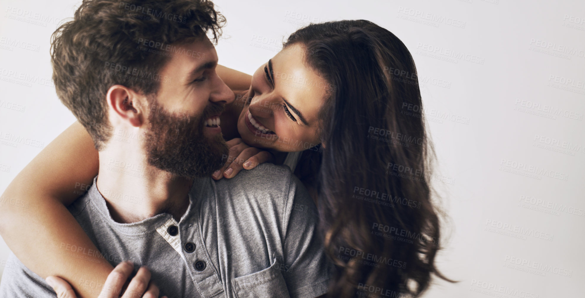 Buy stock photo Couple, smile and hug by white background for love, romance and partnership in studio with pride. Man, woman and happiness on backdrop for support, bonding and together in morning for anniversary 