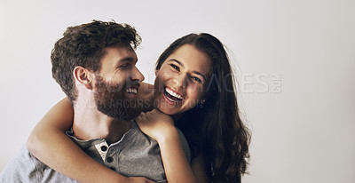 Buy stock photo Shot of an affectionate young couple sharing a romantic moment in the bedroom at home