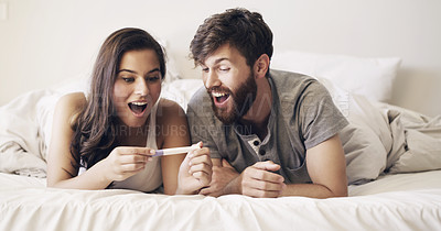 Buy stock photo Happy couple on bed, surprise and pregnancy test, shock and excited for future family, life, love and happiness. Positive results, man with pregnant woman in bedroom and good news in home together.