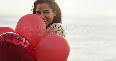 Buy stock photo Cropped shot of a beautiful young woman holding a bunch of balloons